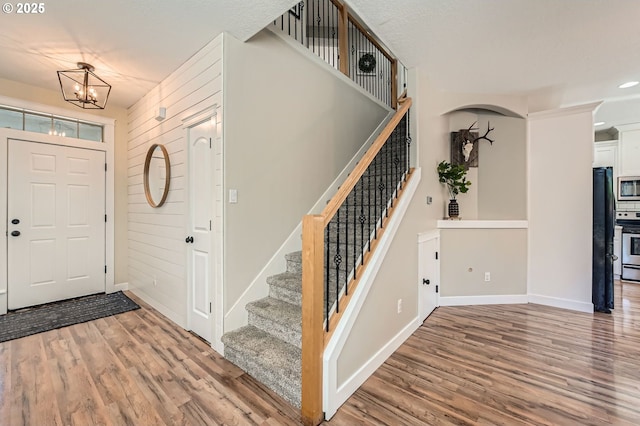 607 E Kennedy Ct, Carlton, OR 97111 - foyer entrance featuring wood finished floors, stairs, a chandelier, and baseboards