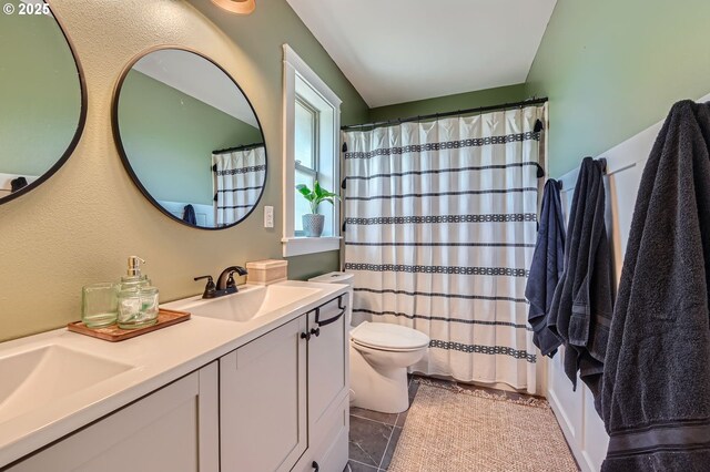 607 E Kennedy Ct, Carlton, OR 97111 - bathroom with toilet, double vanity, tile patterned floors, and a shower with curtain