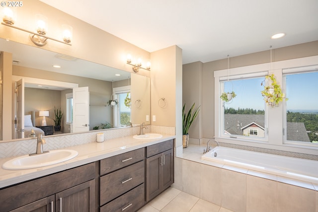 840 Chikamin Loop, Silverton, OR 97381 - ensuite bathroom with double vanity, healthy amount of natural light, a bath, tile patterned flooring, and recessed lighting