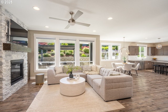 840 Chikamin Loop, Silverton, OR 97381 - living area with dark wood-style floors, a fireplace, a ceiling fan, and recessed lighting