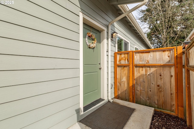 entrance to property featuring fence