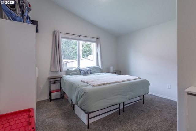 carpeted bedroom with baseboards and vaulted ceiling