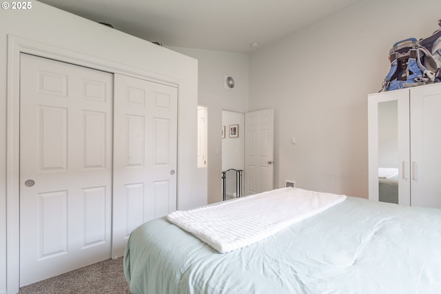 bedroom featuring a closet, carpet flooring, and vaulted ceiling