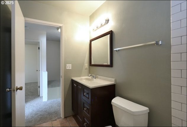 bathroom featuring vanity, toilet, and tile patterned floors