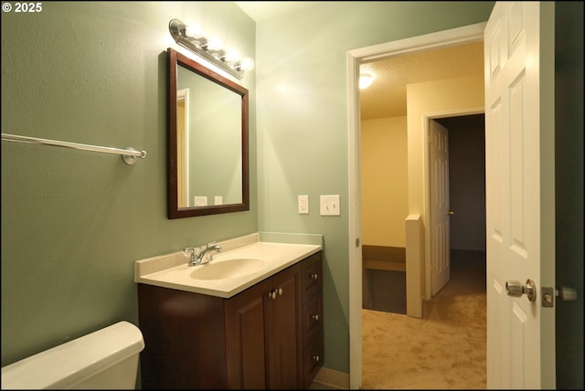 bathroom with toilet and vanity