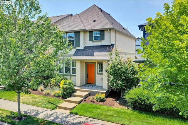 385 SW Mitchum Ter, Beaverton, OR 97006 - view of front facade with stucco siding, roof with shingles, and a front lawn