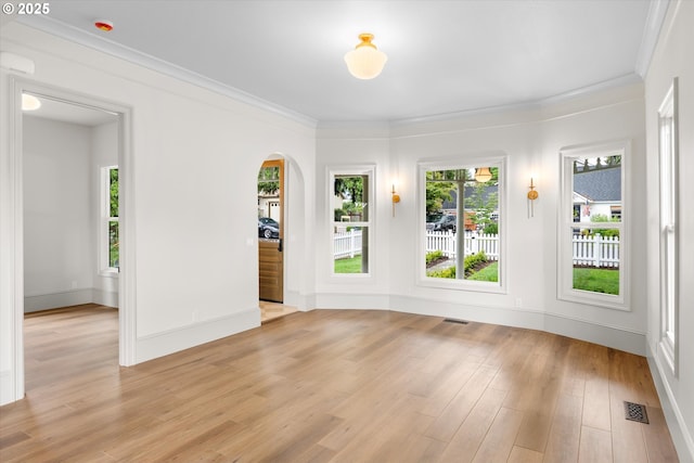 2089 5th Ave, West Linn, OR 97068 - empty room with arched walkways, light wood finished floors, and ornamental molding