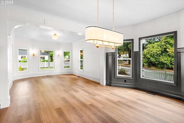 2089 5th Ave, West Linn, OR 97068 - unfurnished dining area featuring light wood-style flooring, healthy amount of natural light, and ornamental molding