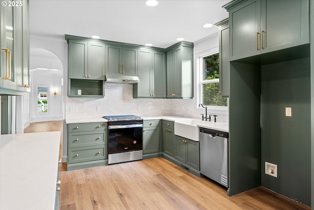 2089 5th Ave, West Linn, OR 97068 - kitchen featuring appliances with stainless steel finishes, green cabinetry, under cabinet range hood, ornamental molding, and recessed lighting