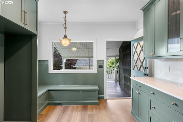 2089 5th Ave, West Linn, OR 97068 - kitchen featuring green cabinets, light wood-style floors, light countertops, decorative light fixtures, and crown molding