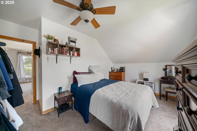 bedroom with light colored carpet, a ceiling fan, baseboards, and vaulted ceiling