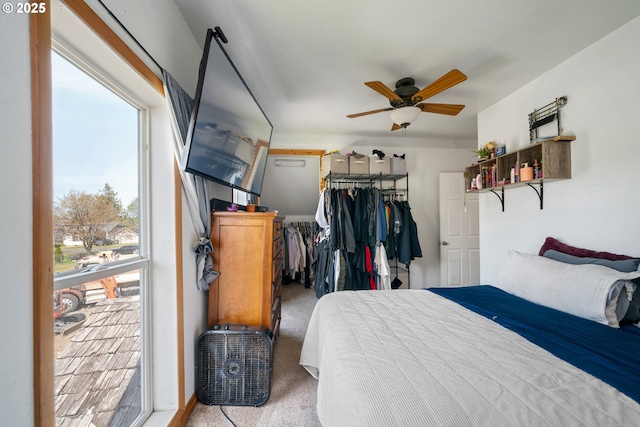bedroom with a closet, carpet flooring, and a ceiling fan