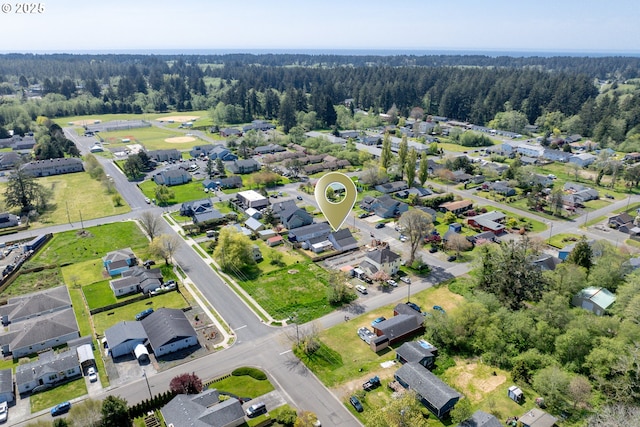 drone / aerial view featuring a view of trees and a residential view