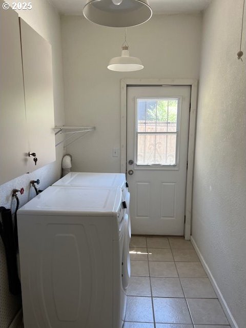 laundry area featuring independent washer and dryer and light tile patterned flooring