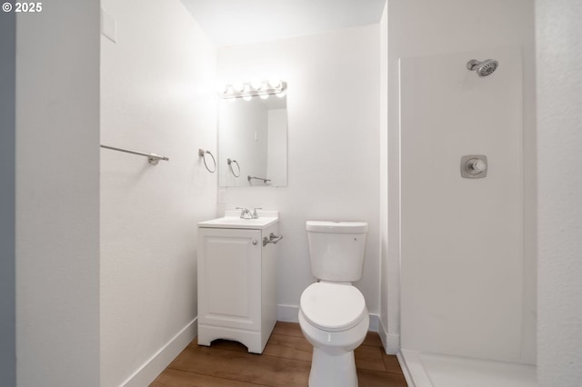 bathroom with hardwood / wood-style floors, vanity, and toilet