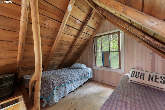bedroom featuring hardwood / wood-style floors, wood ceiling, and wood walls