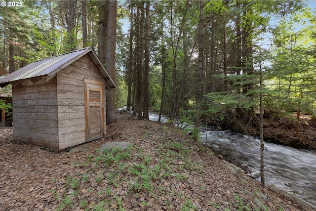 view of shed with a wooded view