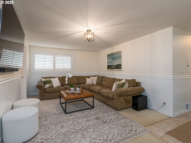 living area with a wainscoted wall