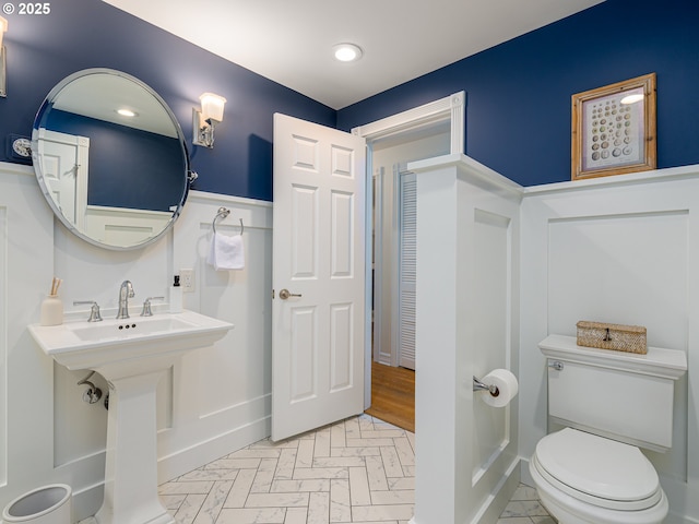 bathroom with recessed lighting, a sink, and toilet