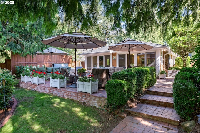 exterior space featuring a yard, a patio, fence, and an outdoor hangout area