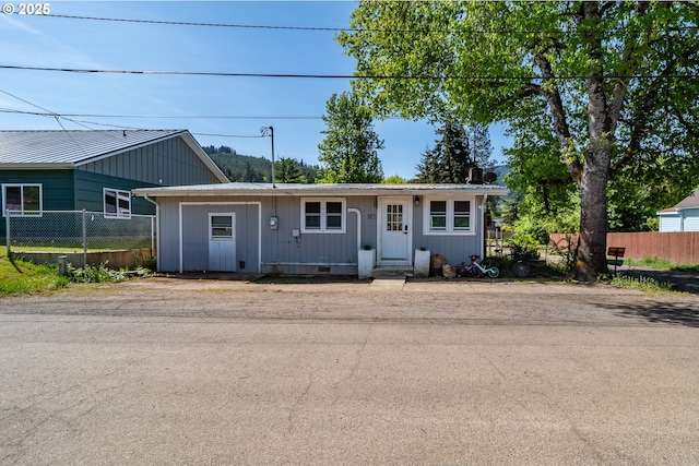ranch-style home with fence
