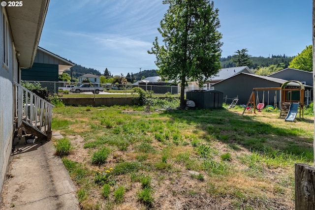 view of yard featuring a playground and fence