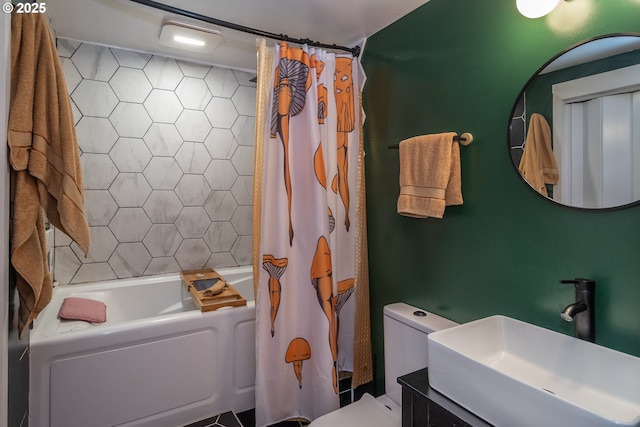 bathroom featuring a sink, shower / bath combo, and toilet