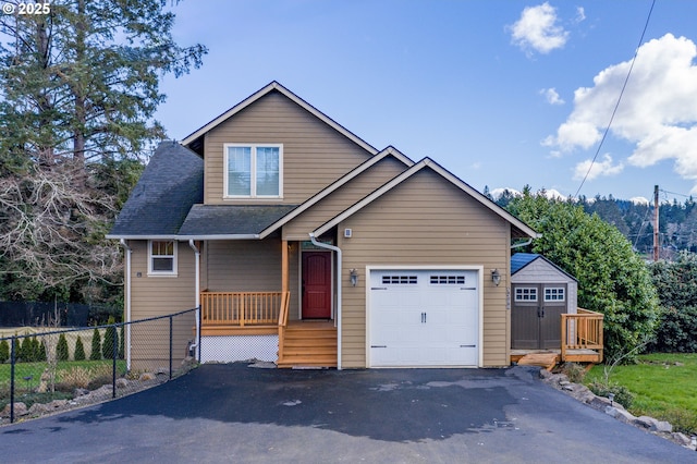 view of front of home featuring a garage, driveway, fence, and roof with shingles