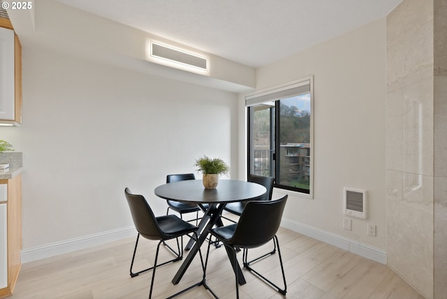 dining area with light hardwood / wood-style flooring