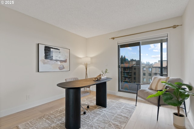 office area featuring a textured ceiling and hardwood / wood-style floors