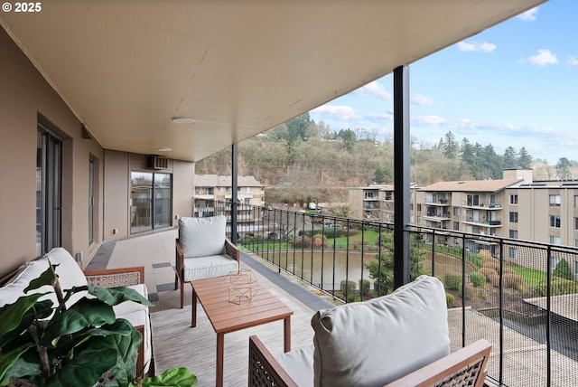 balcony featuring an outdoor hangout area and a water view