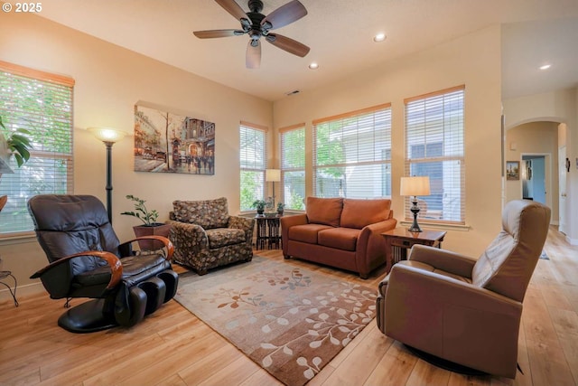 6641 NE Rosebay Dr, Hillsboro, OR 97124 - living room featuring arched walkways, light wood-style floors, ceiling fan, healthy amount of natural light, and recessed lighting