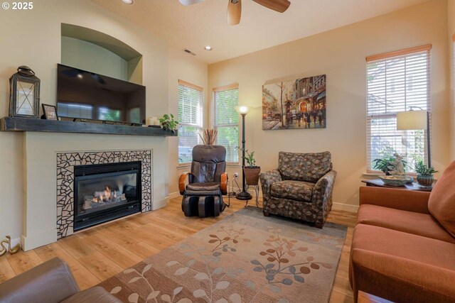 6641 NE Rosebay Dr, Hillsboro, OR 97124 - living room featuring wood finished floors, healthy amount of natural light, a fireplace, baseboards, and recessed lighting