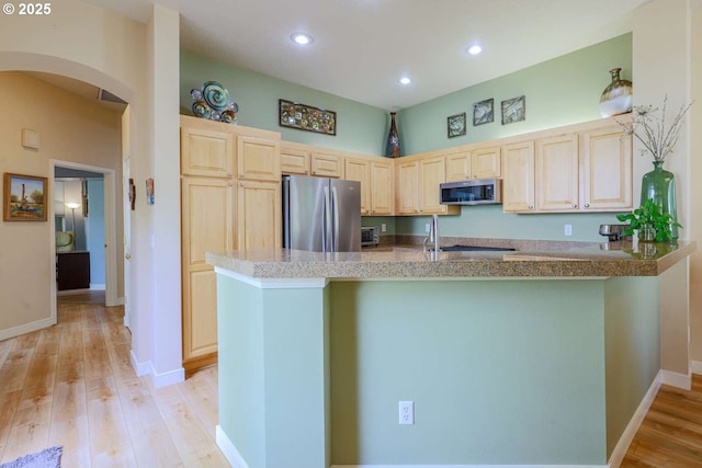 6641 NE Rosebay Dr, Hillsboro, OR 97124 - kitchen with appliances with stainless steel finishes, light brown cabinets, arched walkways, light wood finished floors, and recessed lighting