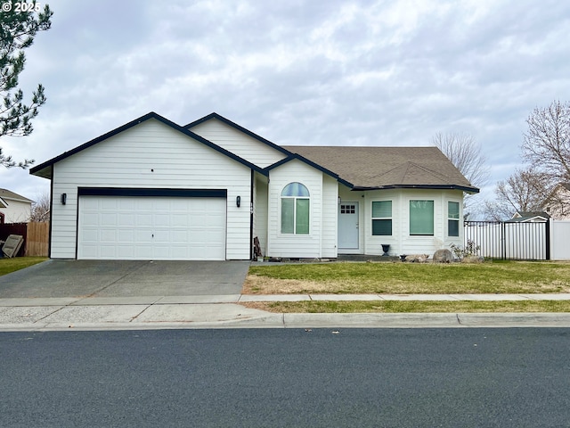 ranch-style home with a garage and a front lawn