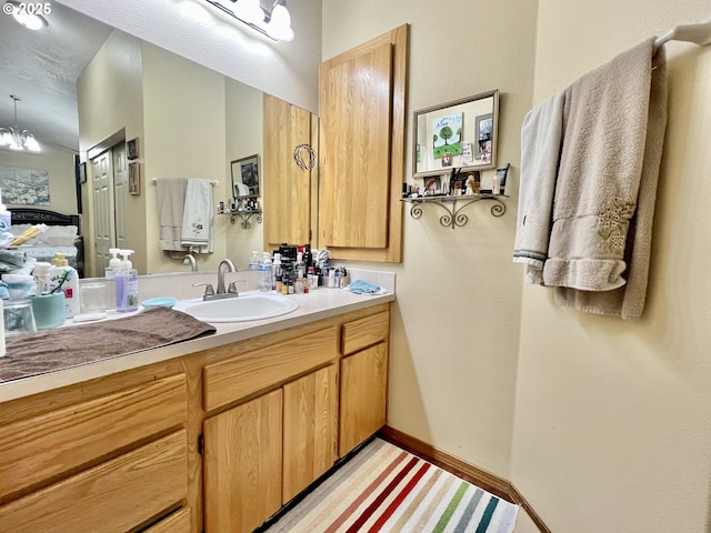 bathroom with vanity and a notable chandelier