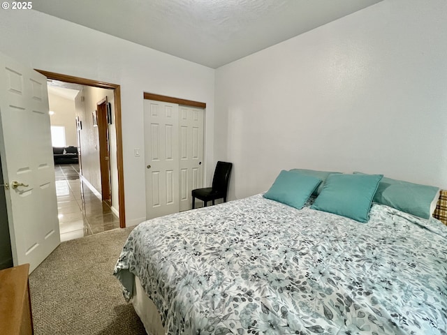 carpeted bedroom with a closet