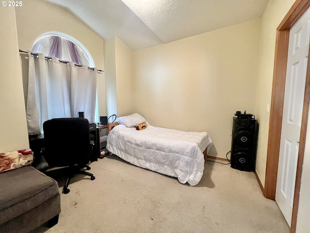 bedroom with light carpet and vaulted ceiling