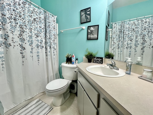 bathroom featuring vanity, tile patterned floors, and toilet