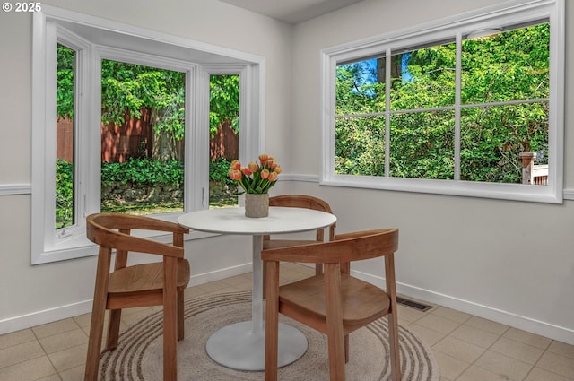 dining space with light tile patterned floors, baseboards, and visible vents