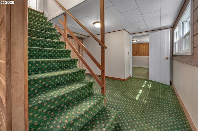 stairs with carpet floors and baseboards