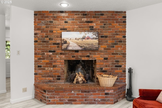 93933 Marcola Rd, Marcola, OR 97454 - detailed view of wood finished floors, a brick fireplace, and a textured ceiling