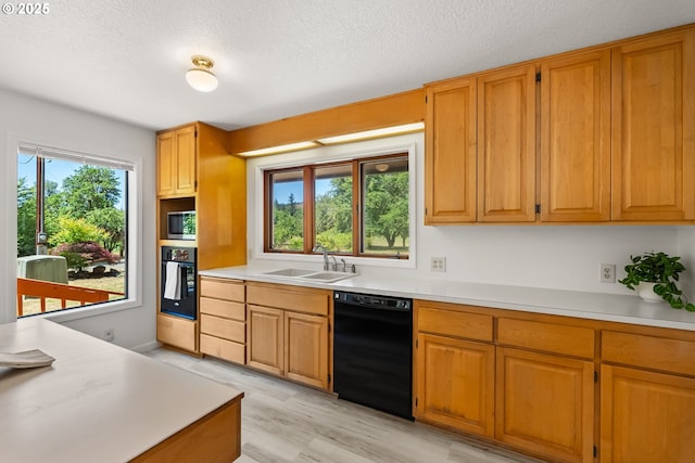 93933 Marcola Rd, Marcola, OR 97454 - kitchen with black appliances, light countertops, a textured ceiling, and brown cabinets