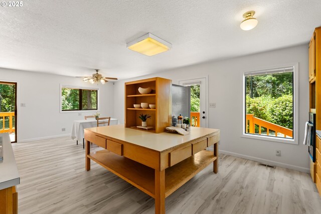 93933 Marcola Rd, Marcola, OR 97454 - dining room with light wood-style flooring, a textured ceiling, and a ceiling fan