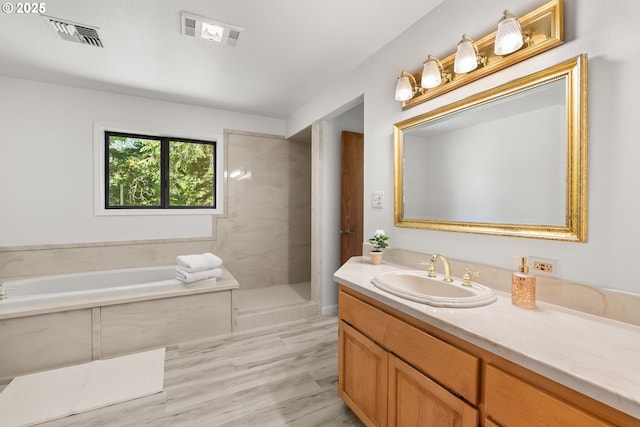 93933 Marcola Rd, Marcola, OR 97454 - bathroom with vanity, a bath, a walk in shower, and wood finished floors