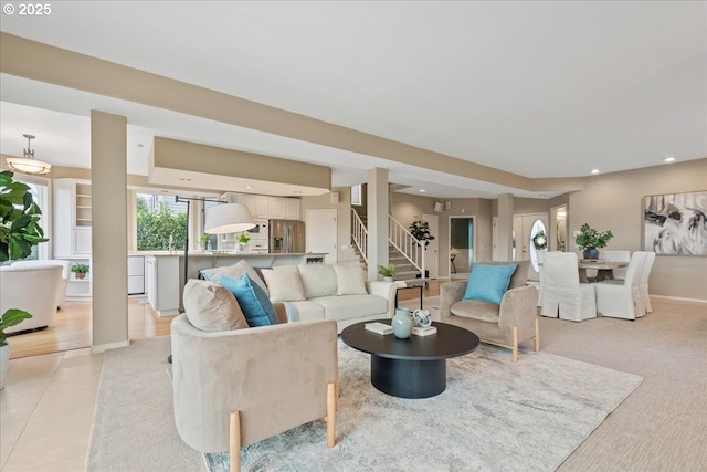 living area with recessed lighting, stairway, and baseboards