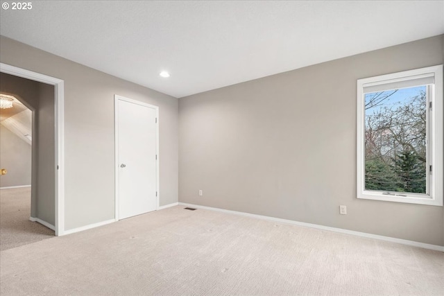 unfurnished bedroom with recessed lighting, light colored carpet, visible vents, and baseboards