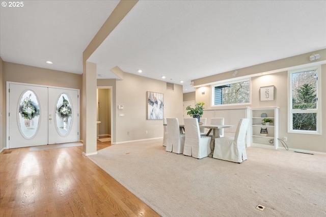 foyer with visible vents, recessed lighting, french doors, baseboards, and light colored carpet