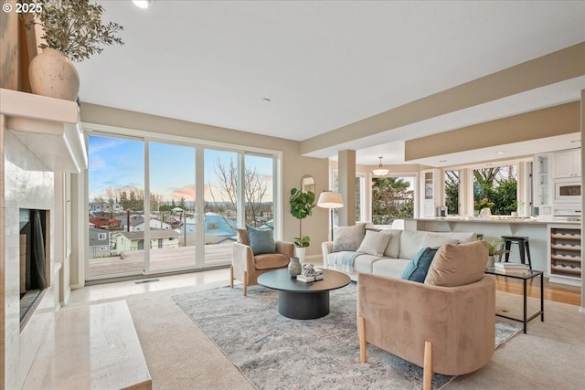 living room with wine cooler, visible vents, and light wood-type flooring