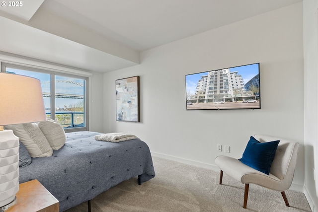 bedroom with baseboards and carpet